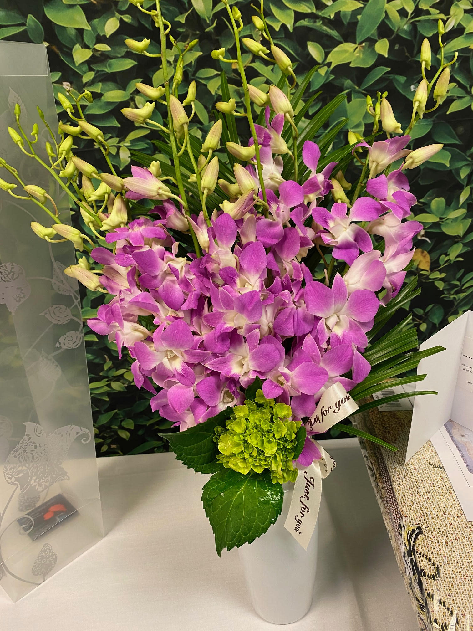 A luxurious bouquet of lavender orchids with a premium, elegant wrap; a customer favorite from Donya's Florals.