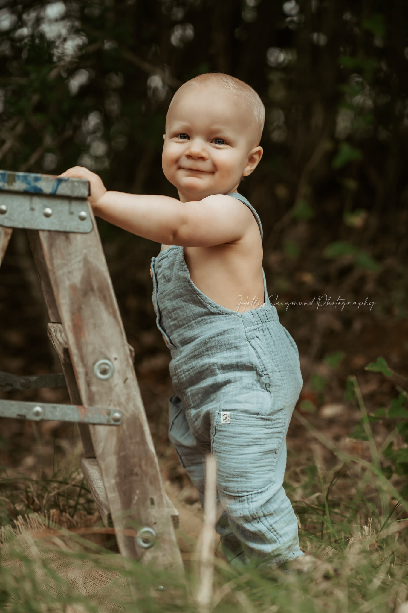 One year old vintage ladder overalls grassy outdoor photo session