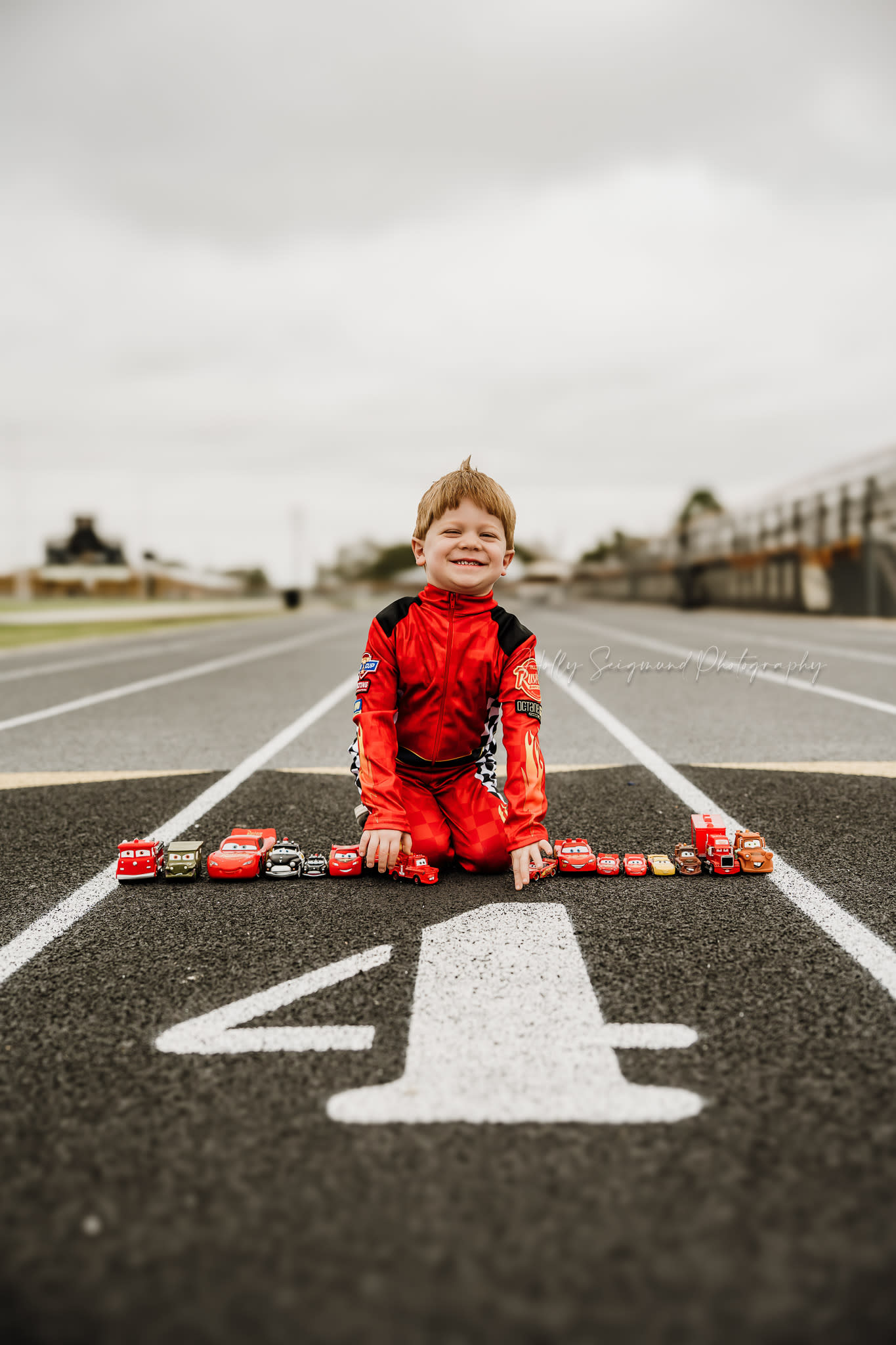 4th birthday photos on a race track with toy cars
