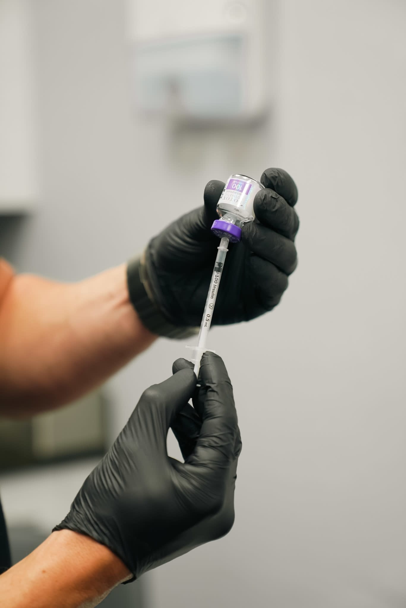 Gloved medical provider preparing Botox Cosmetic in a syringe at Refresh - Aesthetics & Wellness