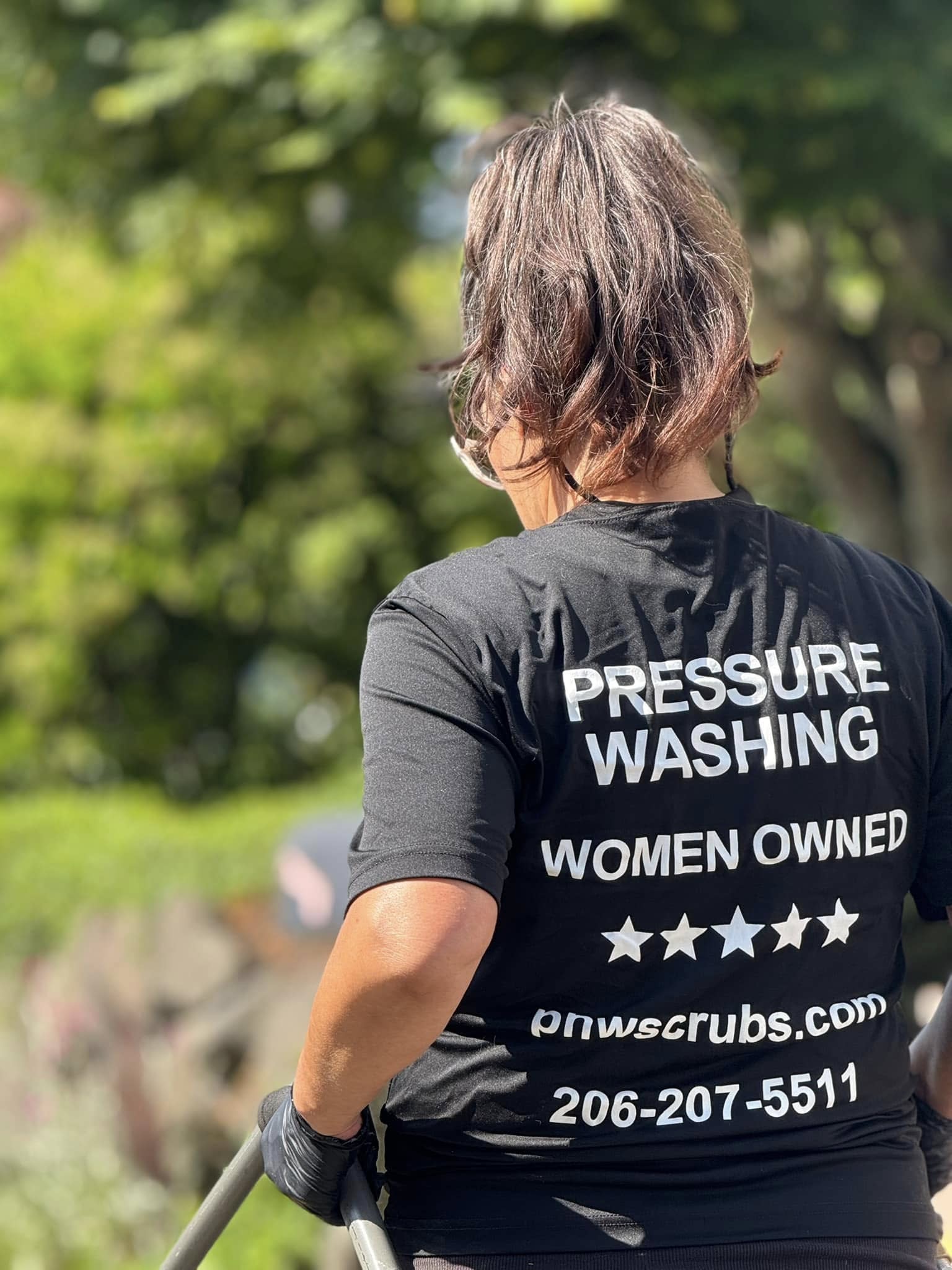 Women owned pressure washing company in Seattle wearing branded PNW Scrubs uniform