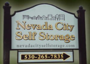 Nevada City Self Storage signage with cityscape and gold lettering