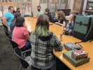 A group of people wearing masks and playing games.
