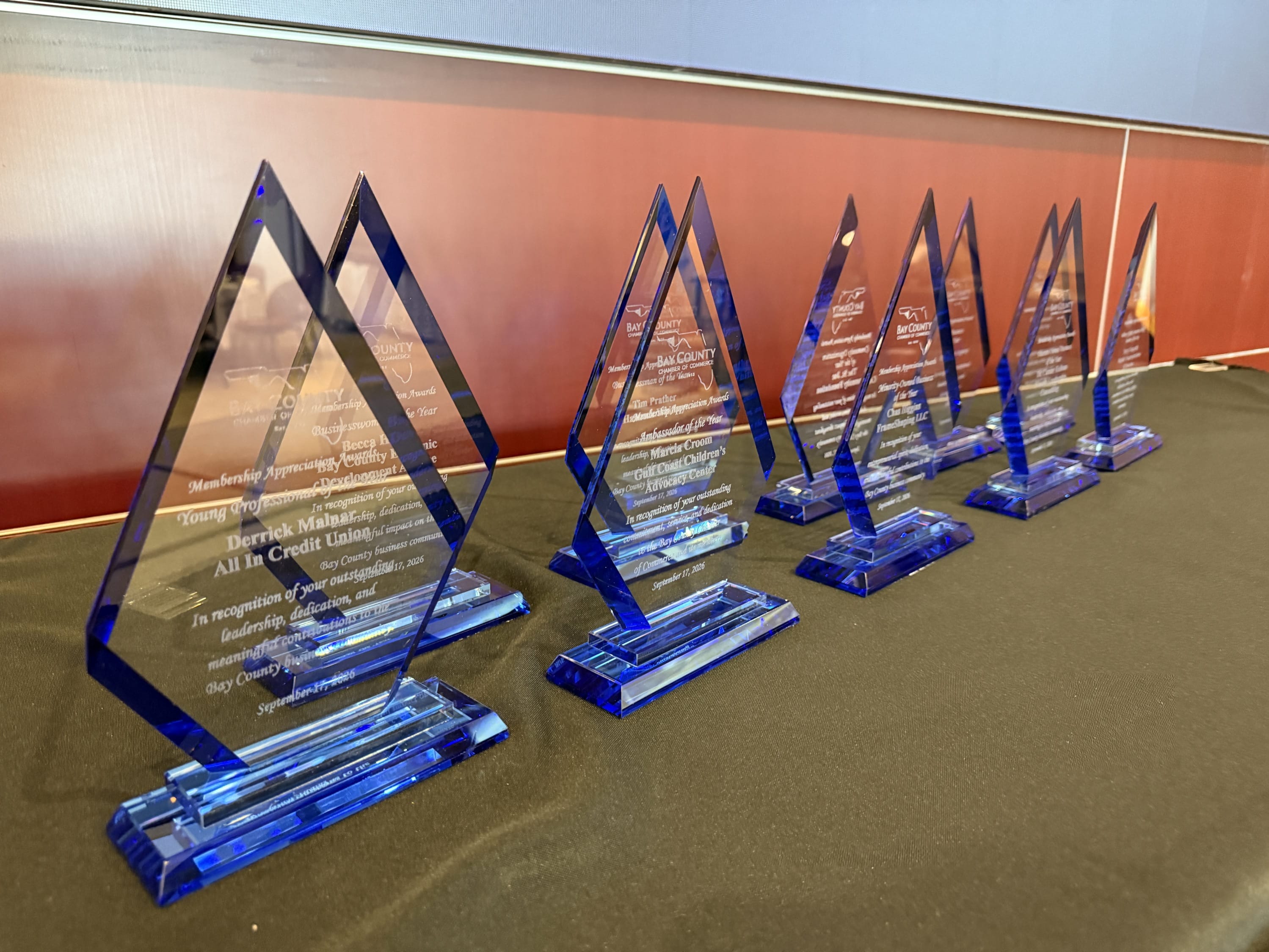 Ten blue crystal awards presented to the 2026 Bay County Chamber Membership Appreciation Award recipients.