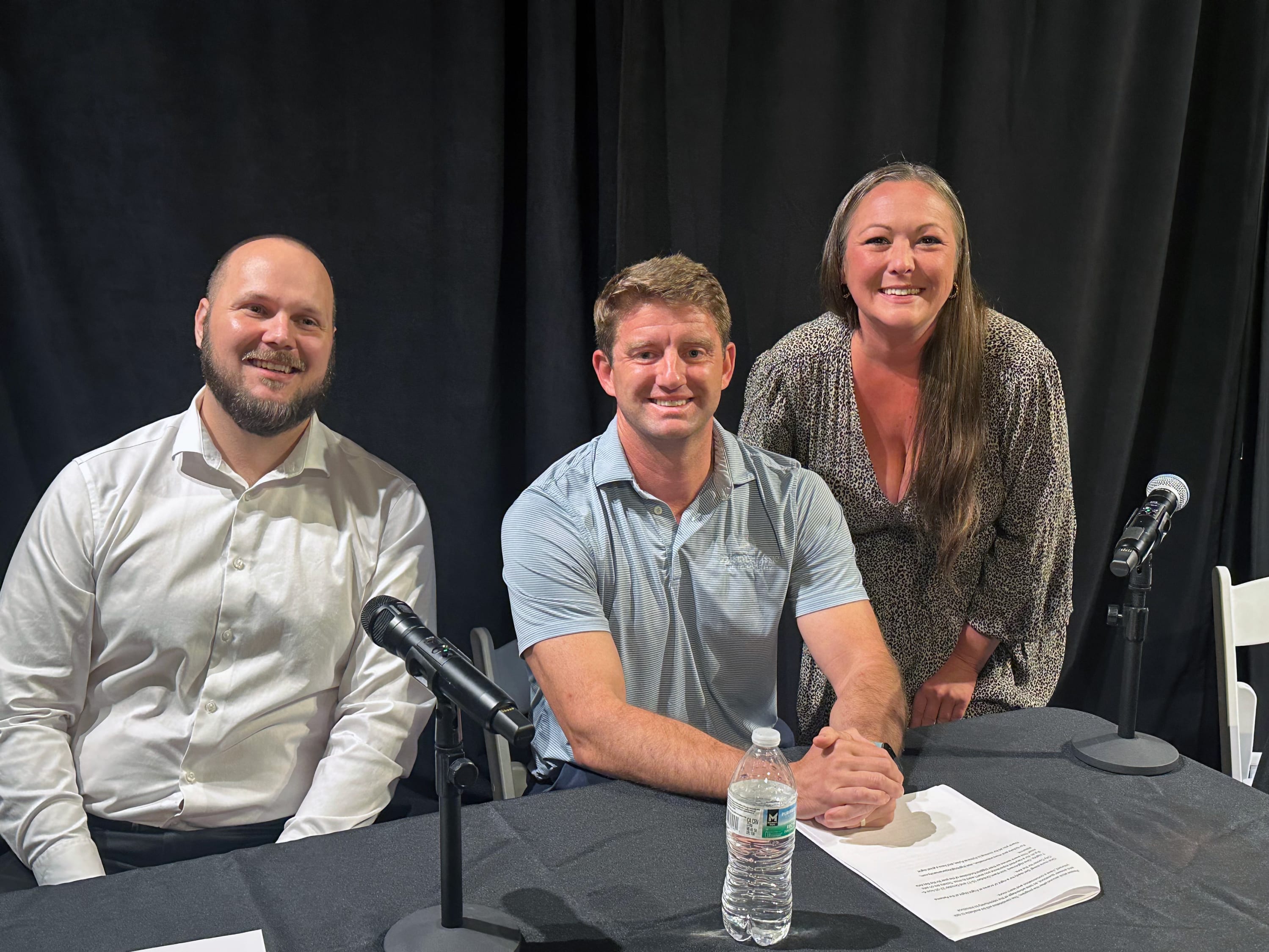 Three Political Pulse event organizers and moderators pose together following the candidate forum.