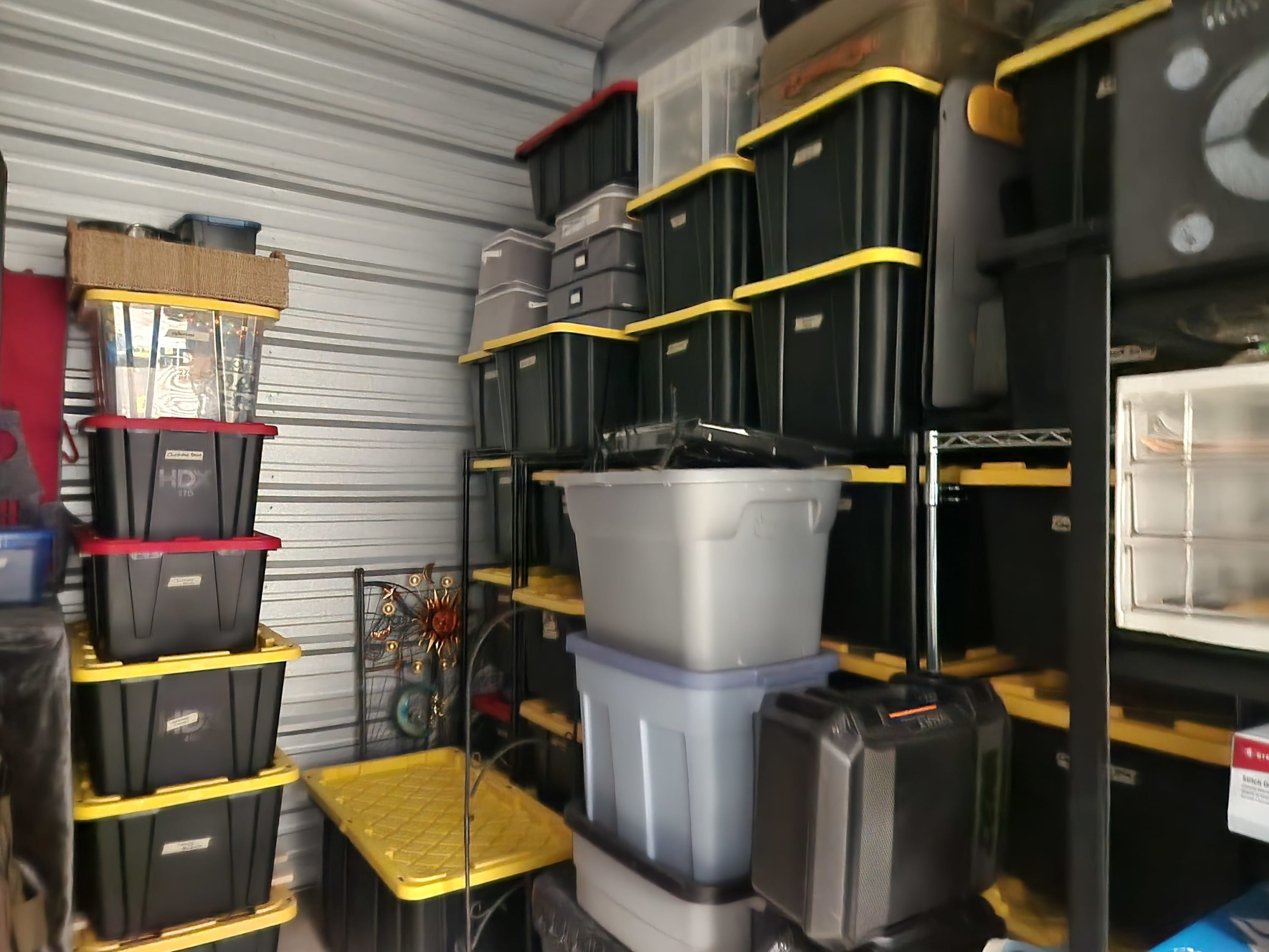 Organized storage unit with labeled totes on shelving after professional organizing service - Venice, FL