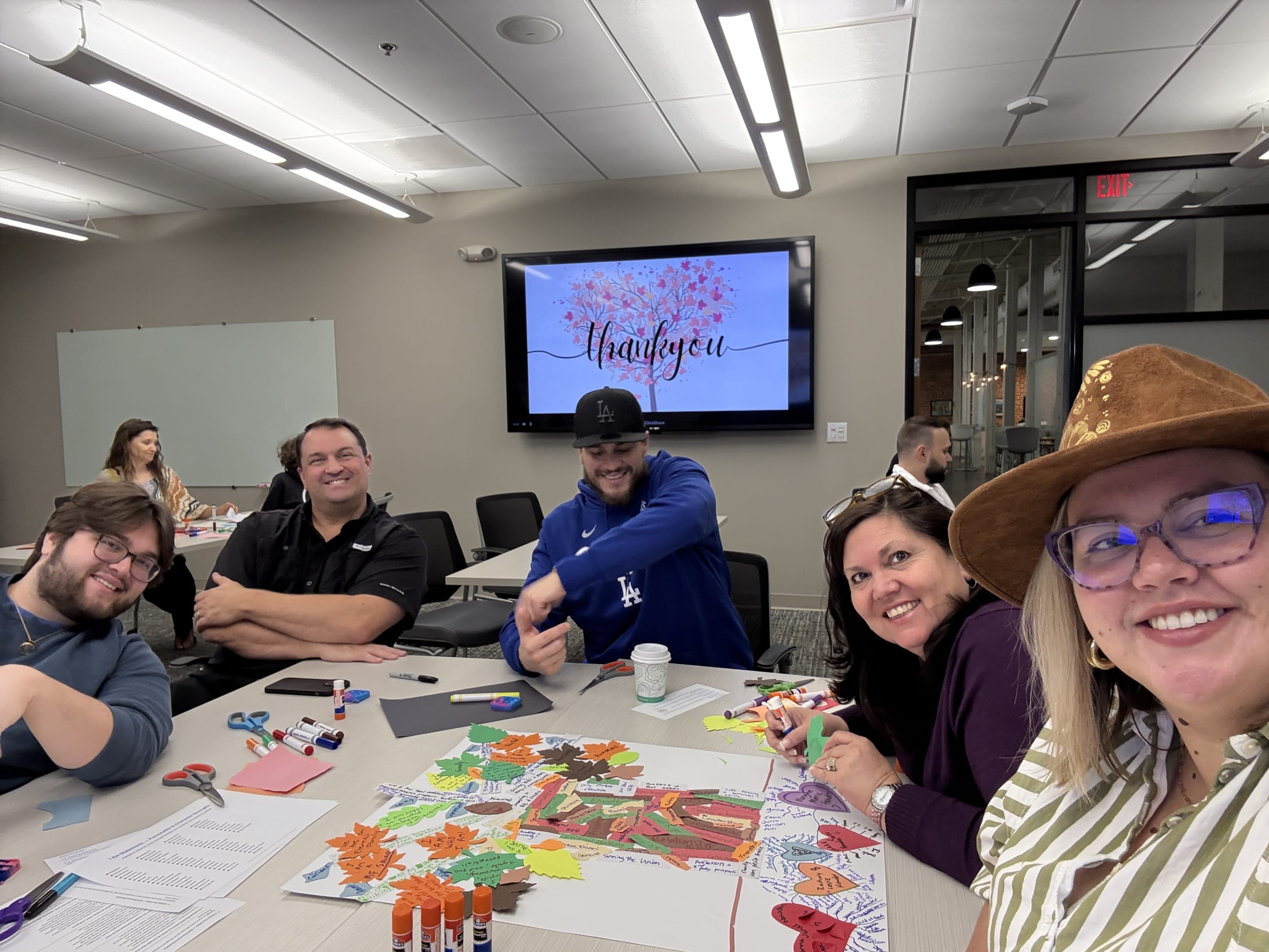 A team working together on a creative activity to recognize their strengths