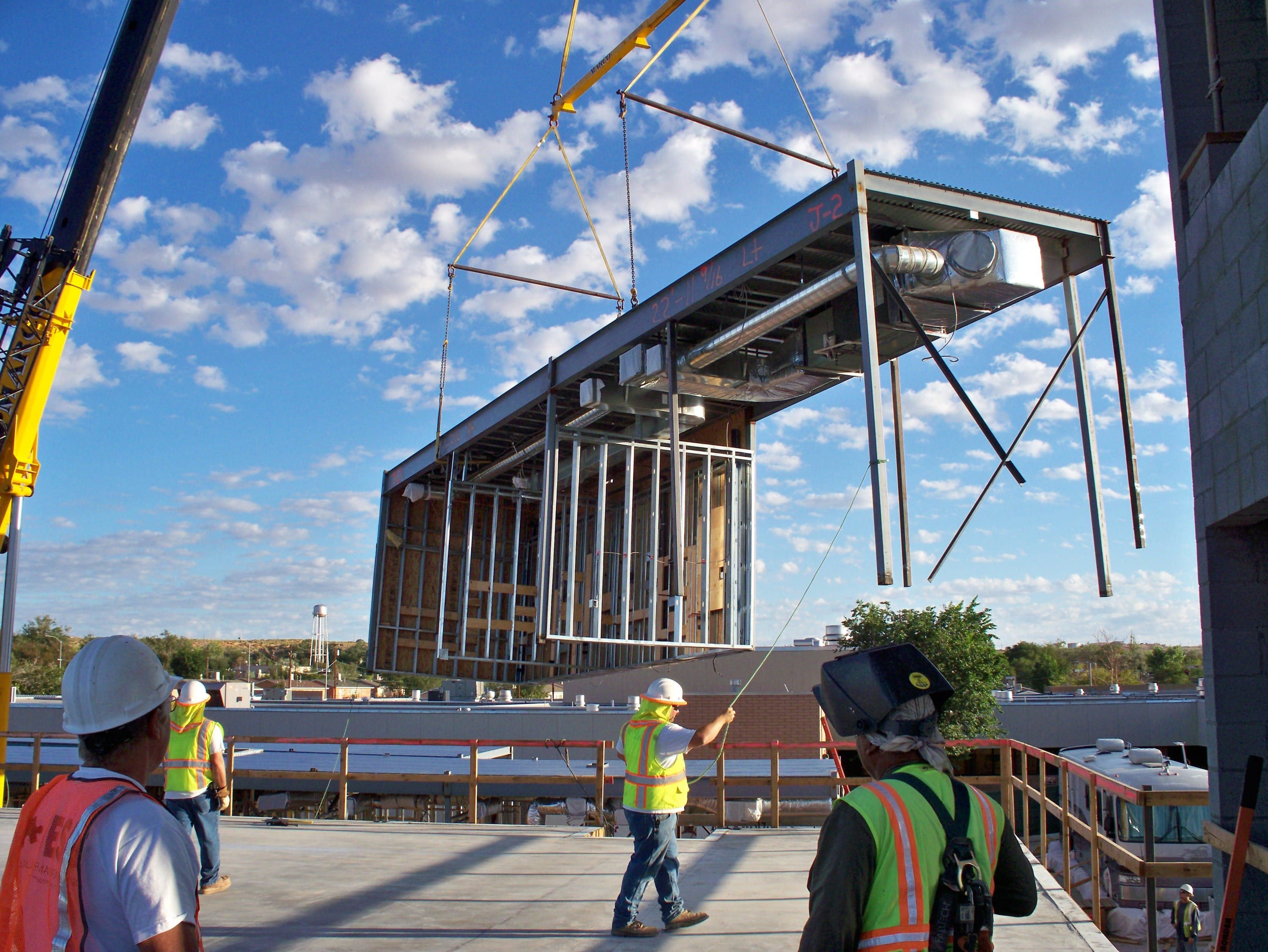 ESB Design+Build employees crane in a modular section on second story of hospital