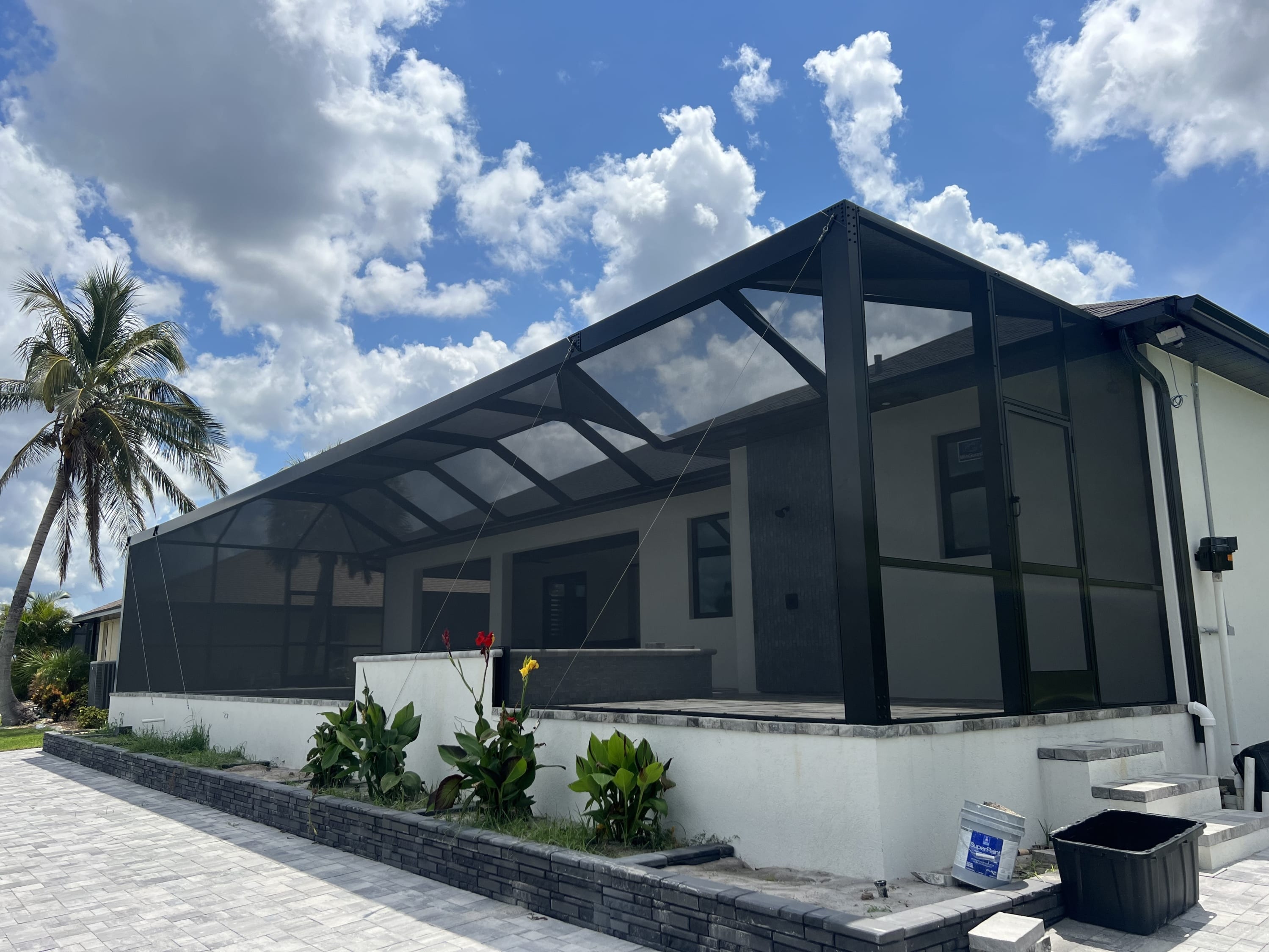 Completed black aluminum pool cage and screened enclosure by Sosnin Builders