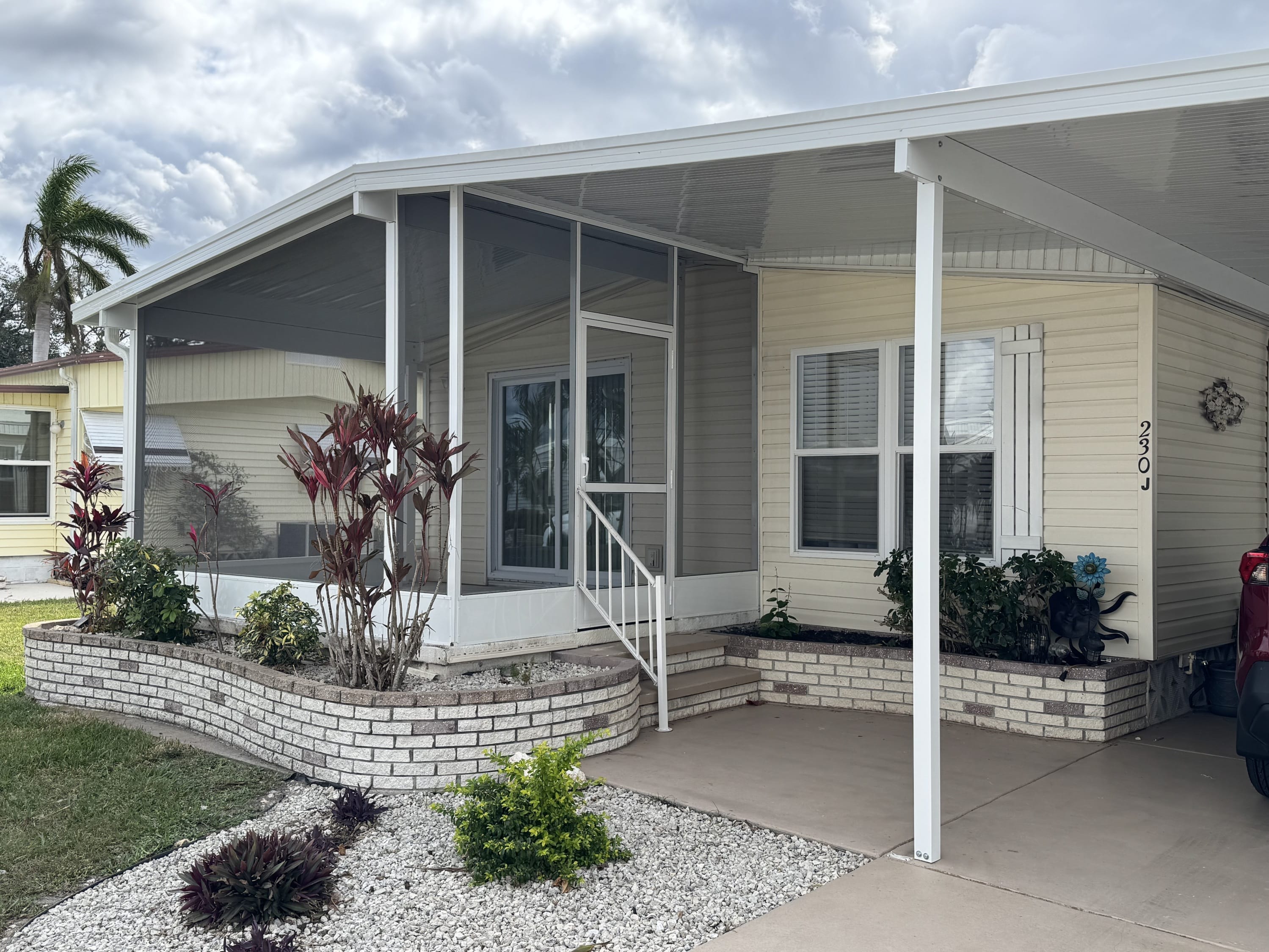 Completed aluminum carport and covered entry for a manufactured home by Sosnin Builders