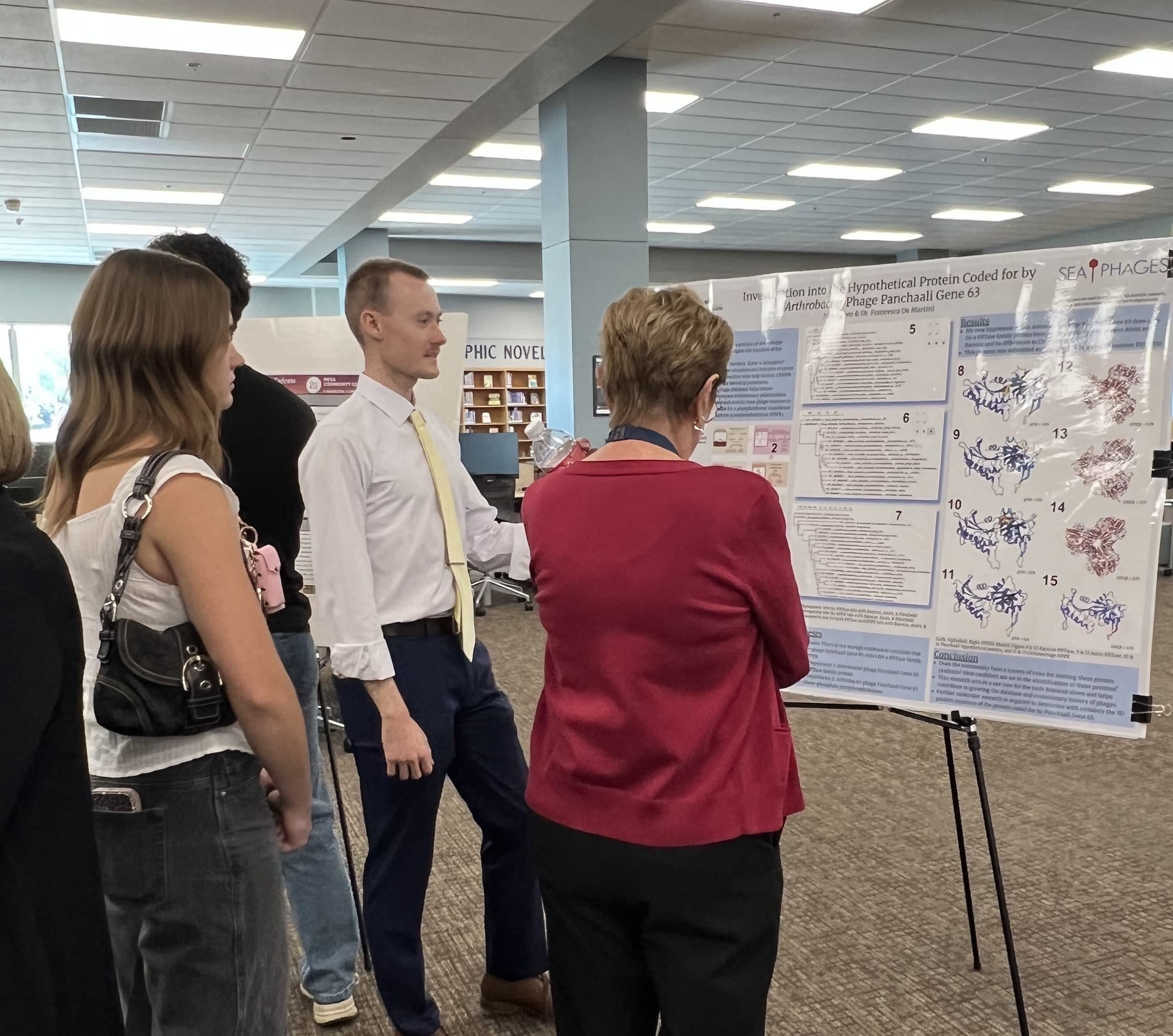Students looking at research poster