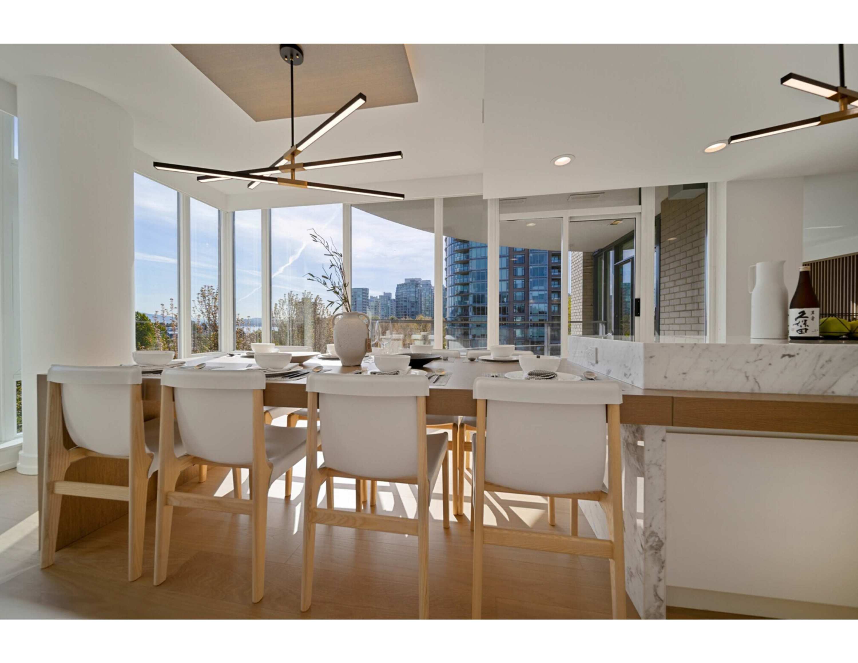 Luxury apartment renovation at 1985 Alberni featuring a bright open dining area, floor-to-ceiling windows, custom millwork, m