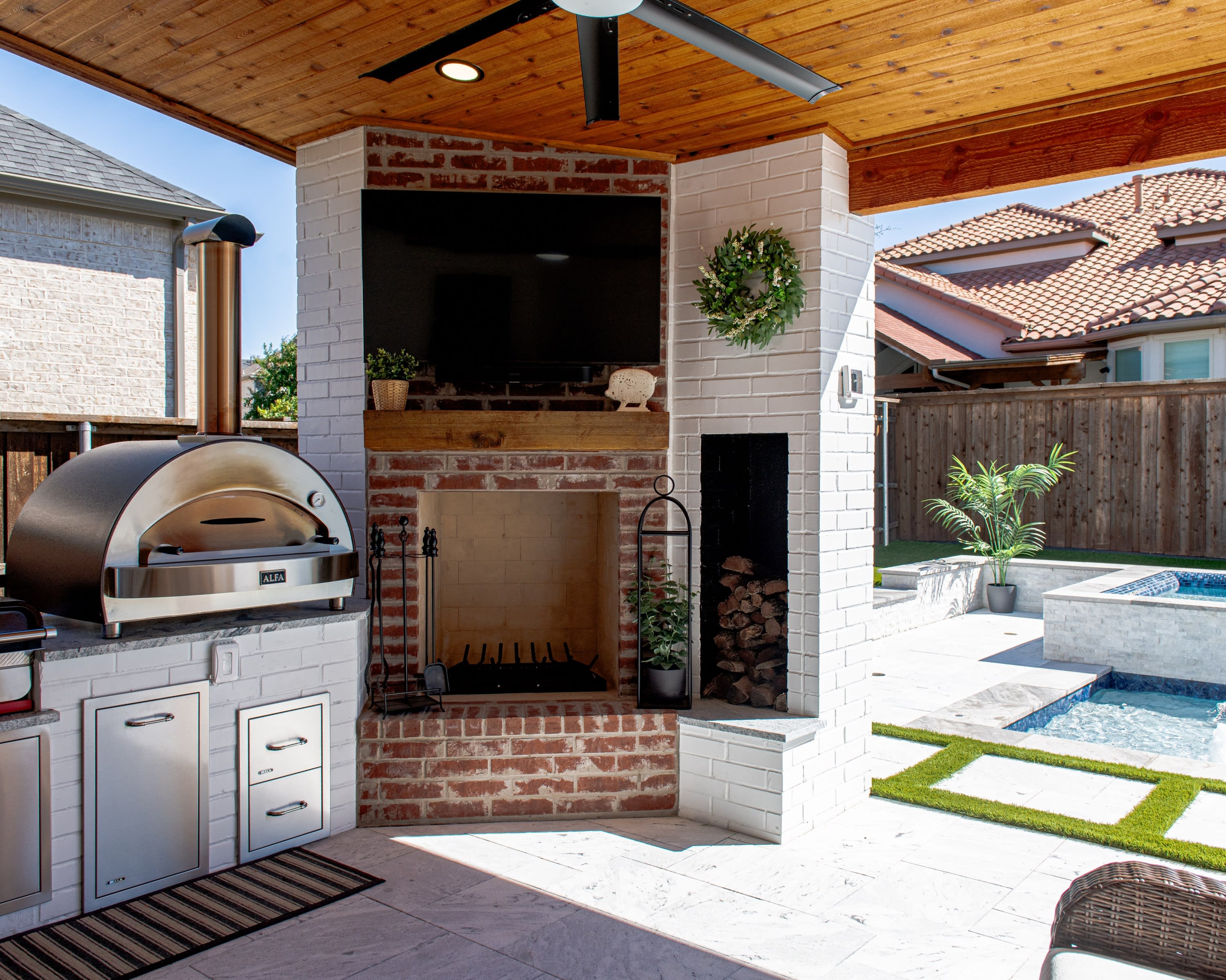 Custom outdoor kitchen and fireplace by Canyon Oak Pools in Frisco, TX
