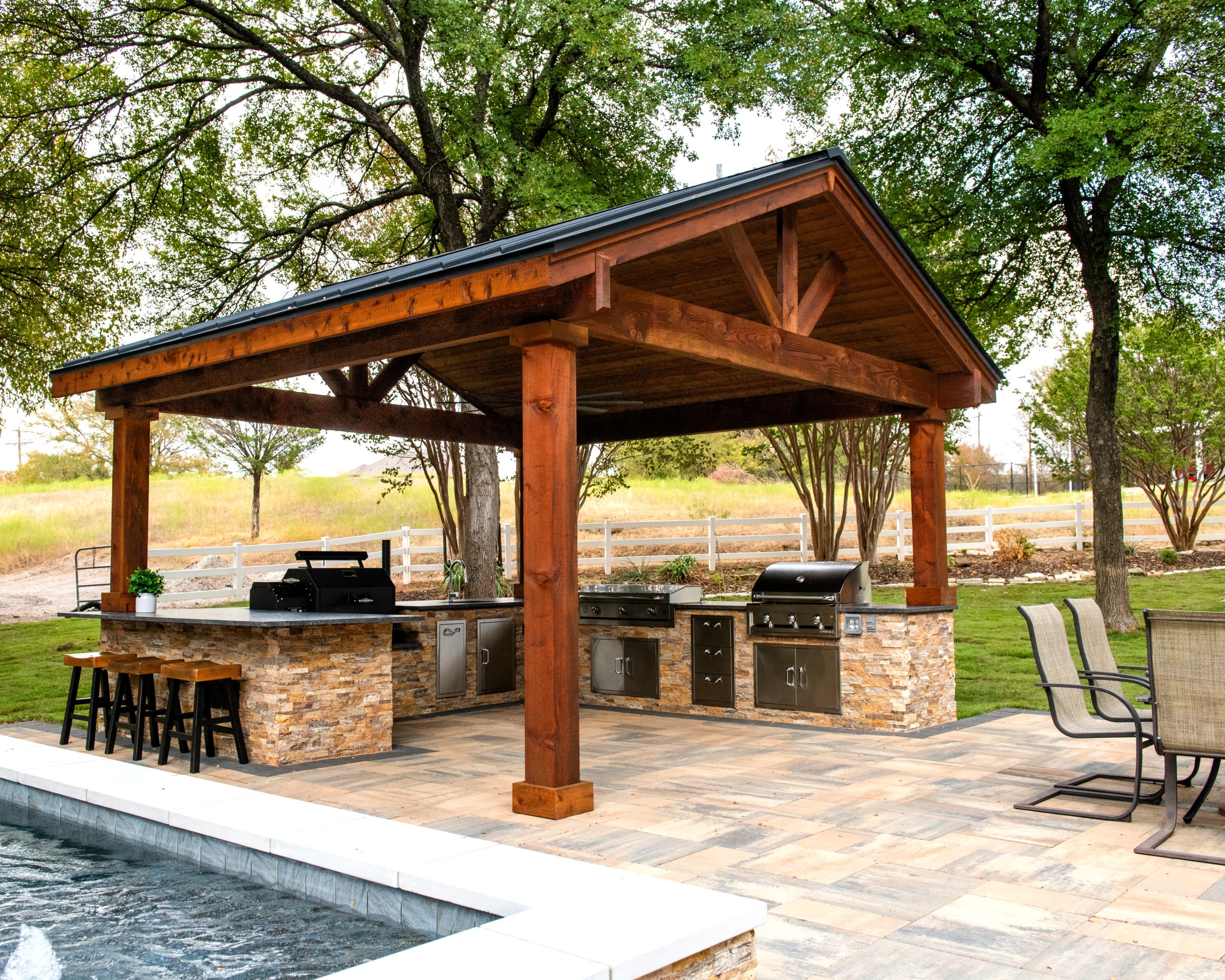 Custom outdoor kitchen and pavilion by Canyon Oak Pools in Roanoke, TX