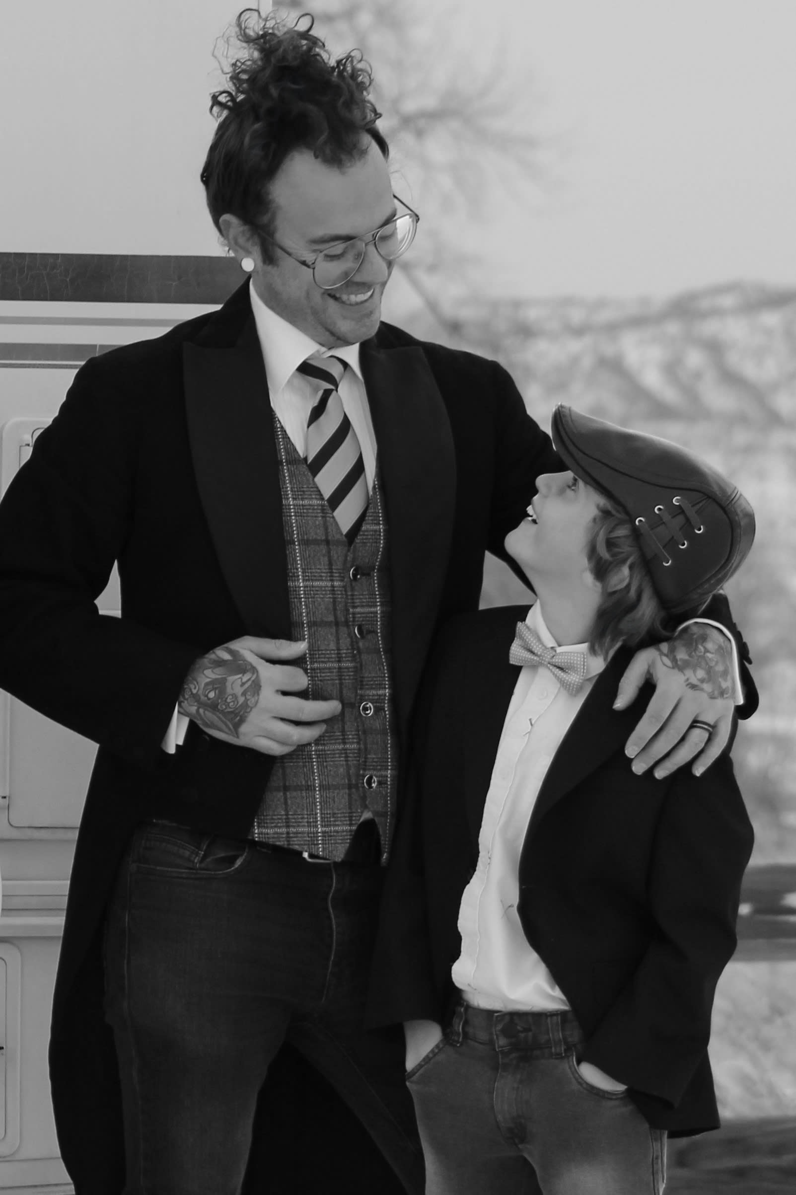 Father and son dressed up in black and white portrait looking at each other