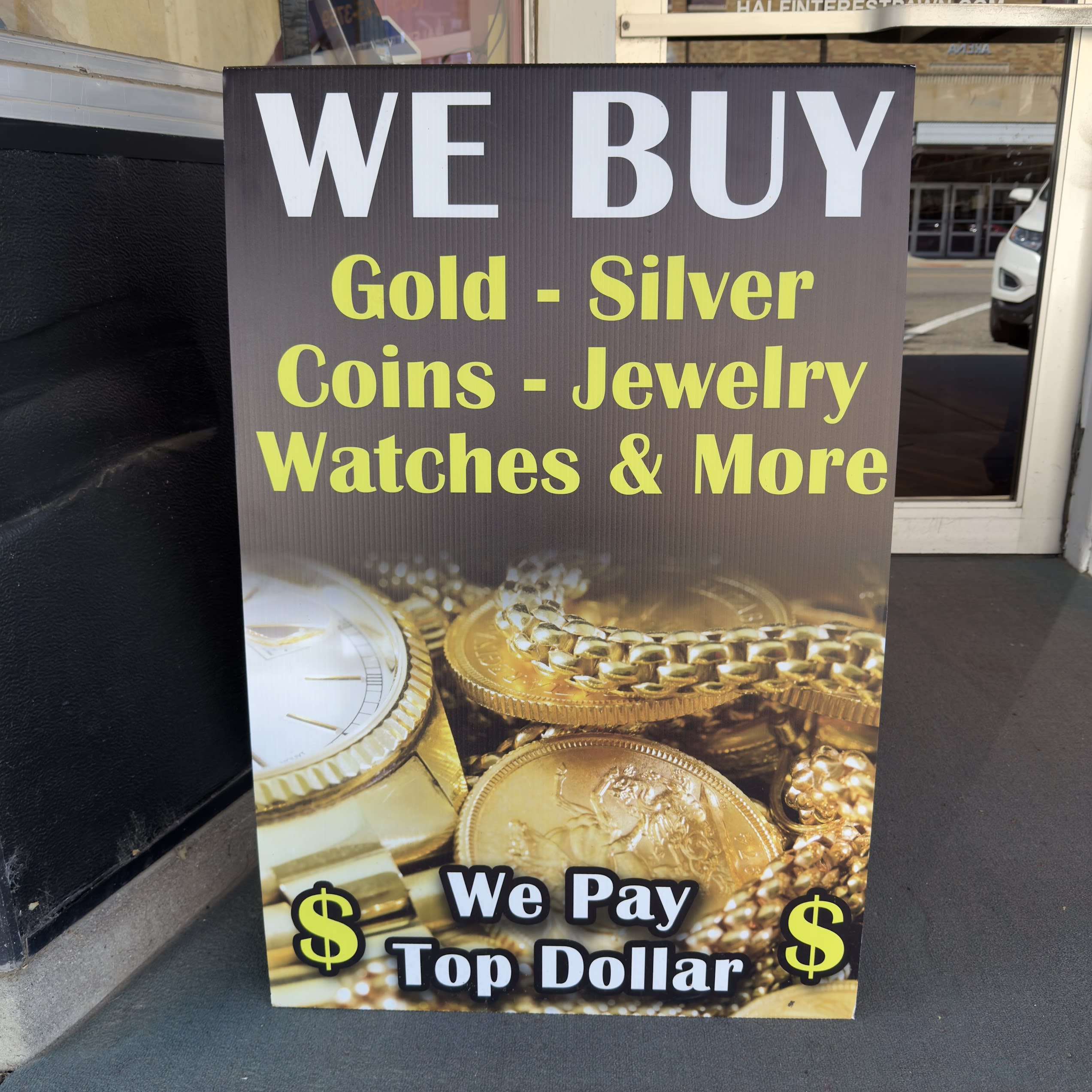 We Buy Gold, Silver, Coins, Jewelry and Watches sign outside Larsen's Jewelry & Half Interest Pawn, Mobridge, SD.