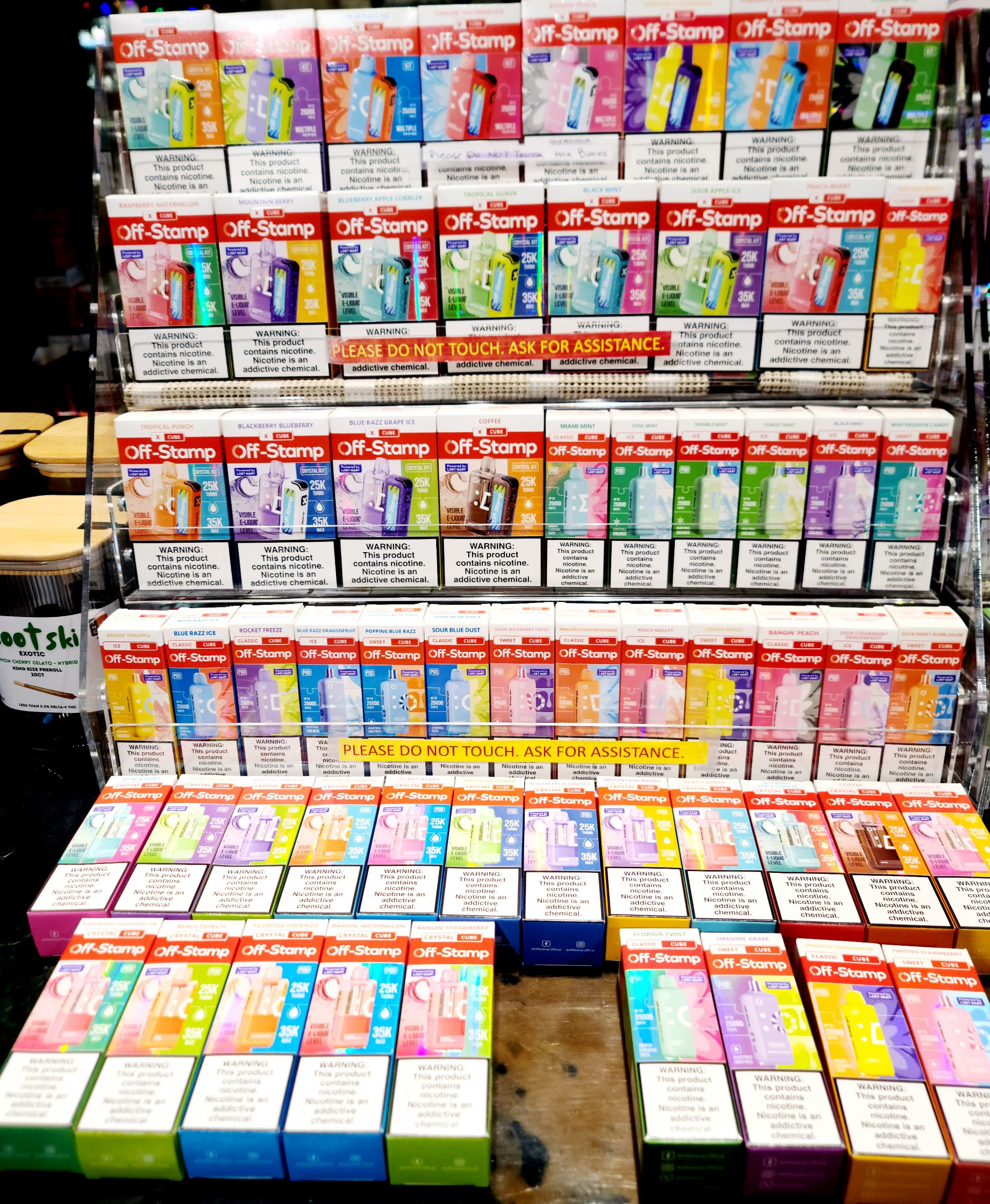 Colorful disposable vape device display wall at Speakeasy Vaporium