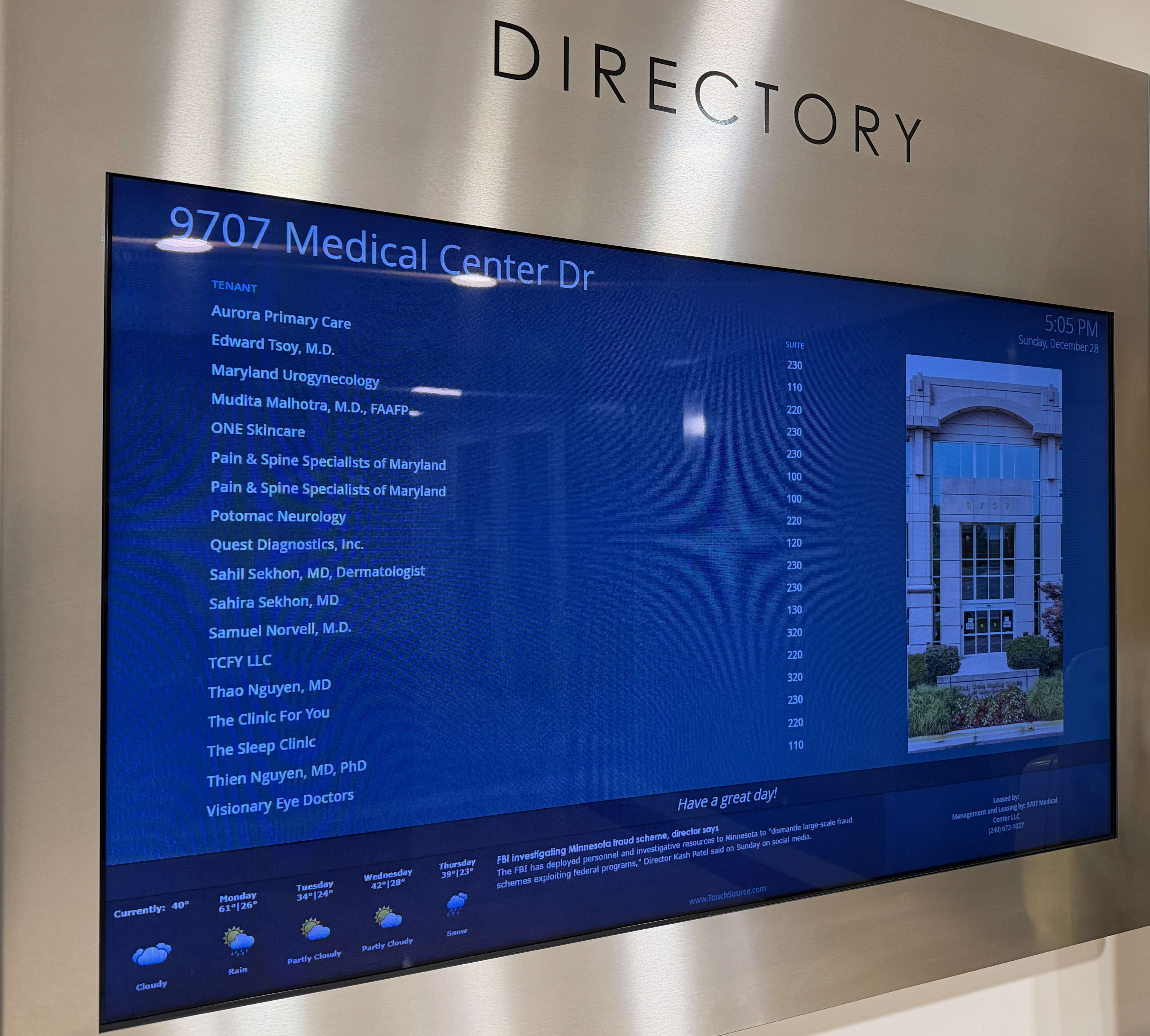 Lobby directory screen listing Aurora Primary Care and Dr. Mudita Malhotra, M.D., Suite 230