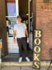 Harmony Books- owner Benjamin Kowalczyk standing at the entrance of Harmony Books