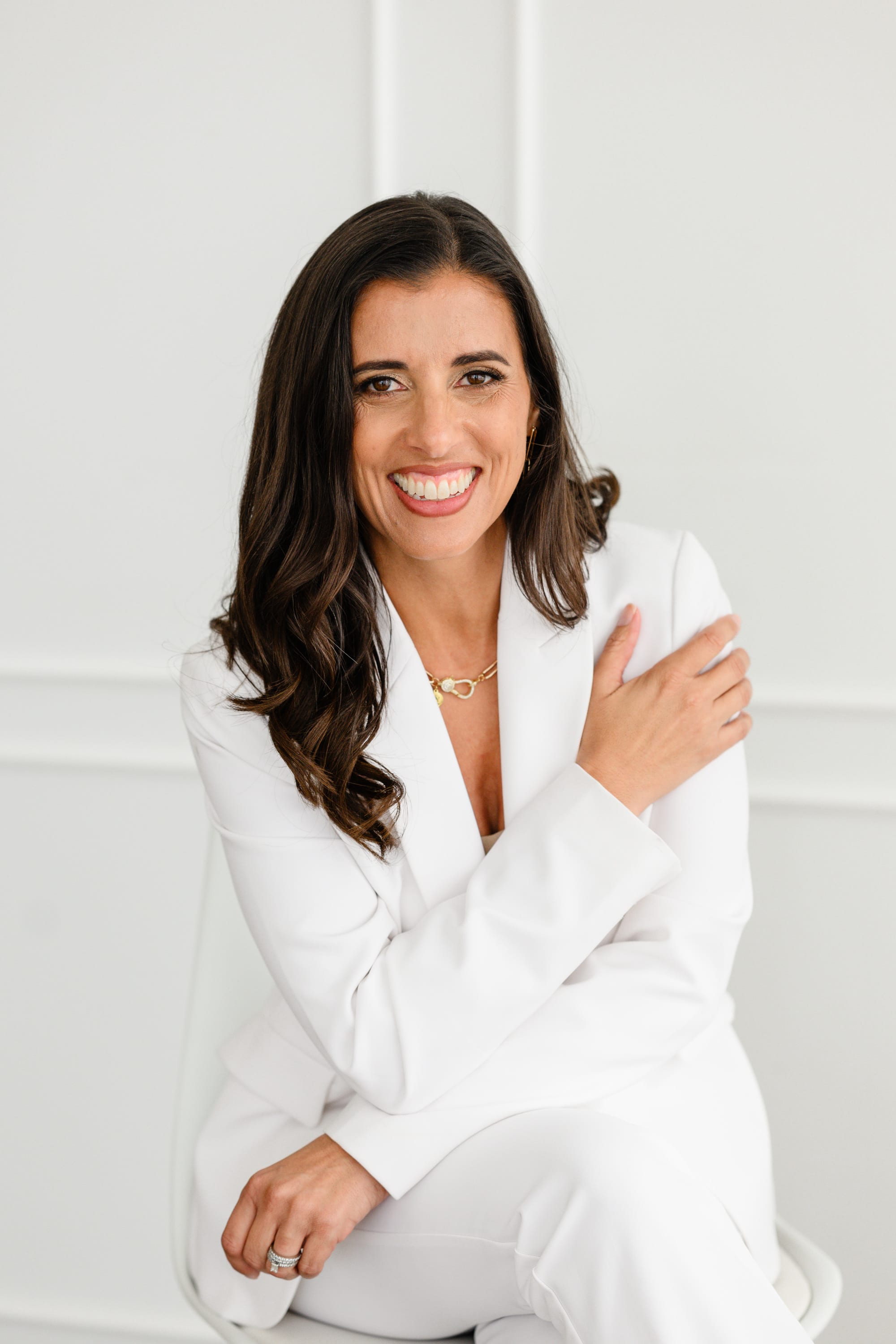 Jocelyn Espejo founder of Branding by Jo wearing a white suit