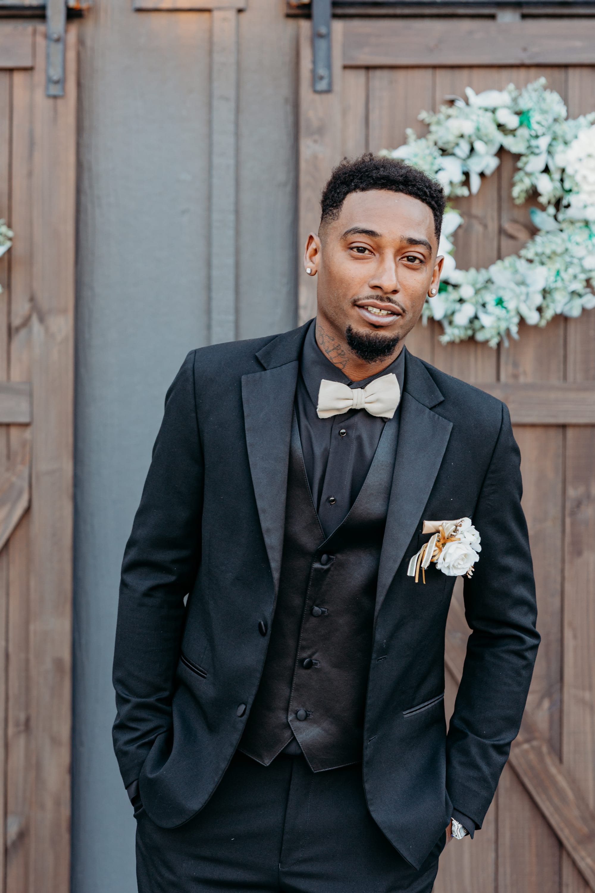 groom portrait in front of rustic barn doors wedding venue South Carolina