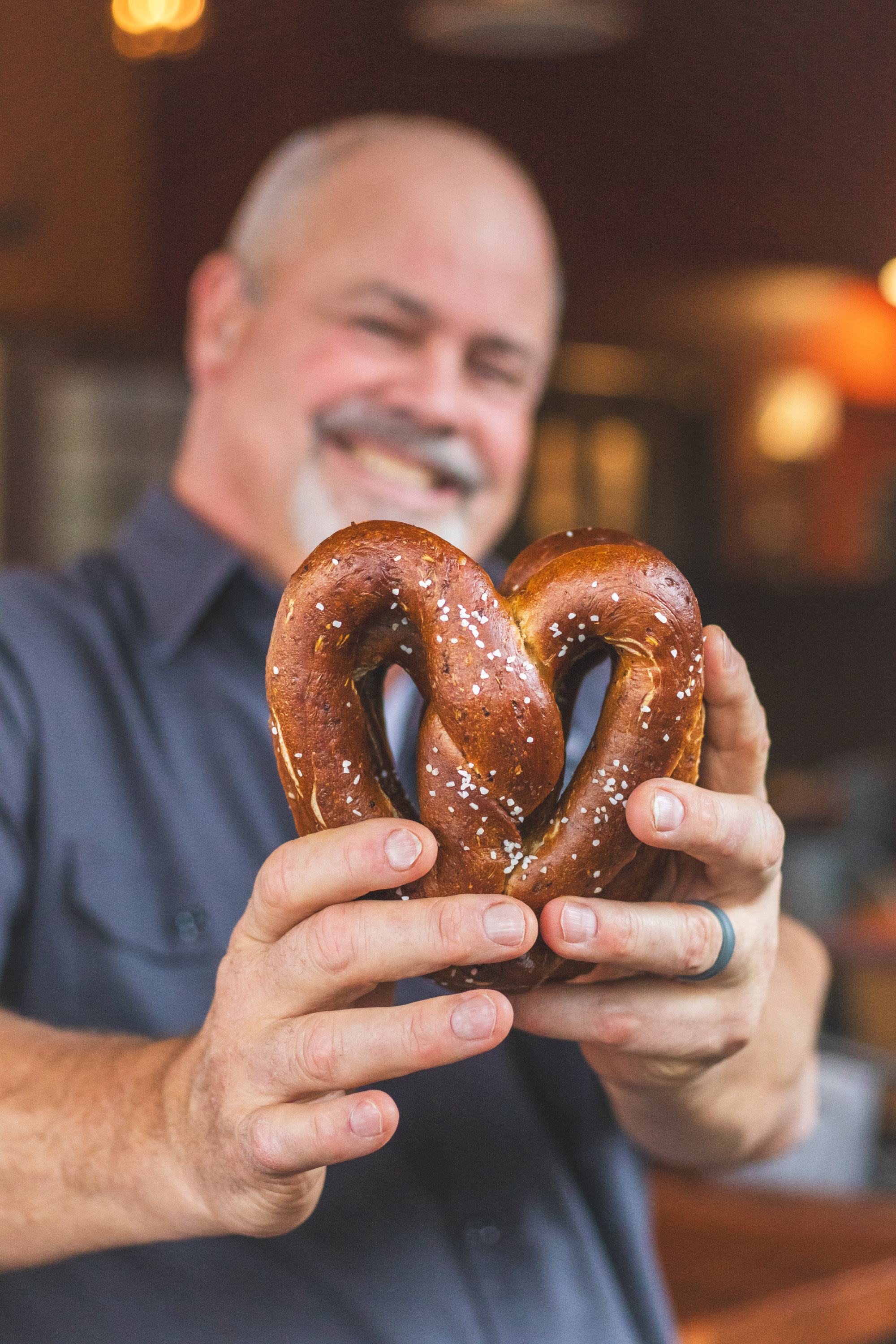 Chef John howie holding a heart shaped house made pretzel