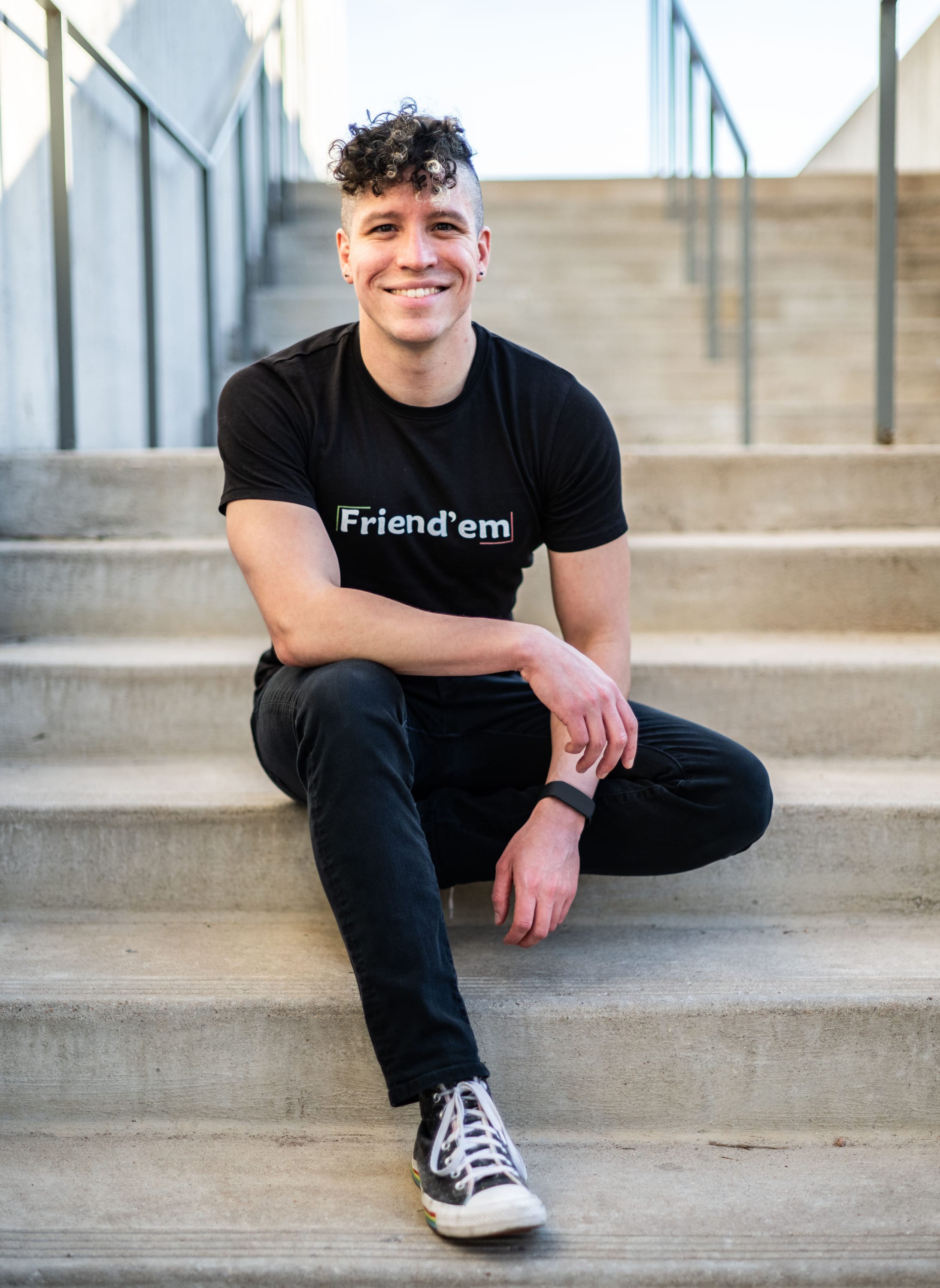 Michael, Found of Friend'em, wearing a black shirt with the Friend'em Logo