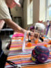 A man decorates a Dia de los Muertos ofrenda