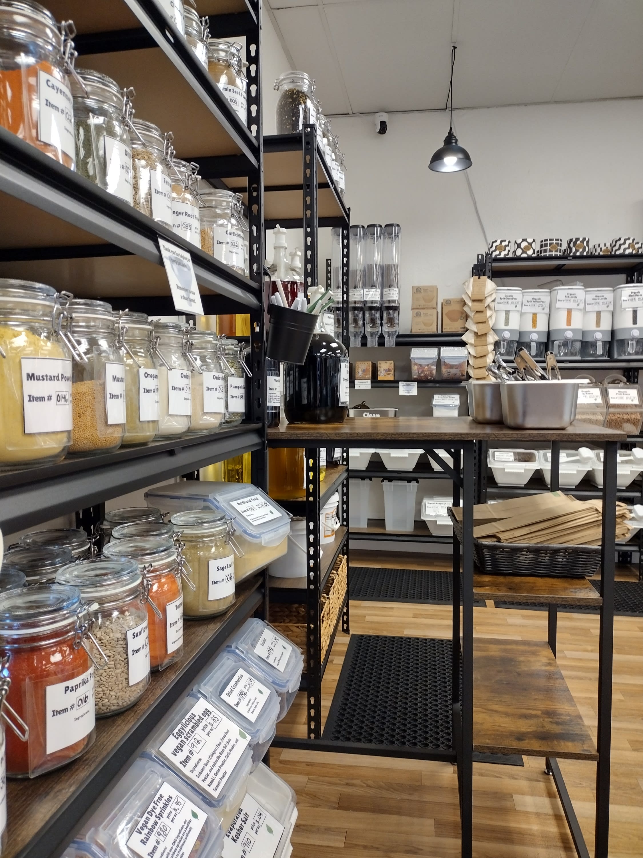 Jars of teas and spices and coffee bean gravity bins in the background