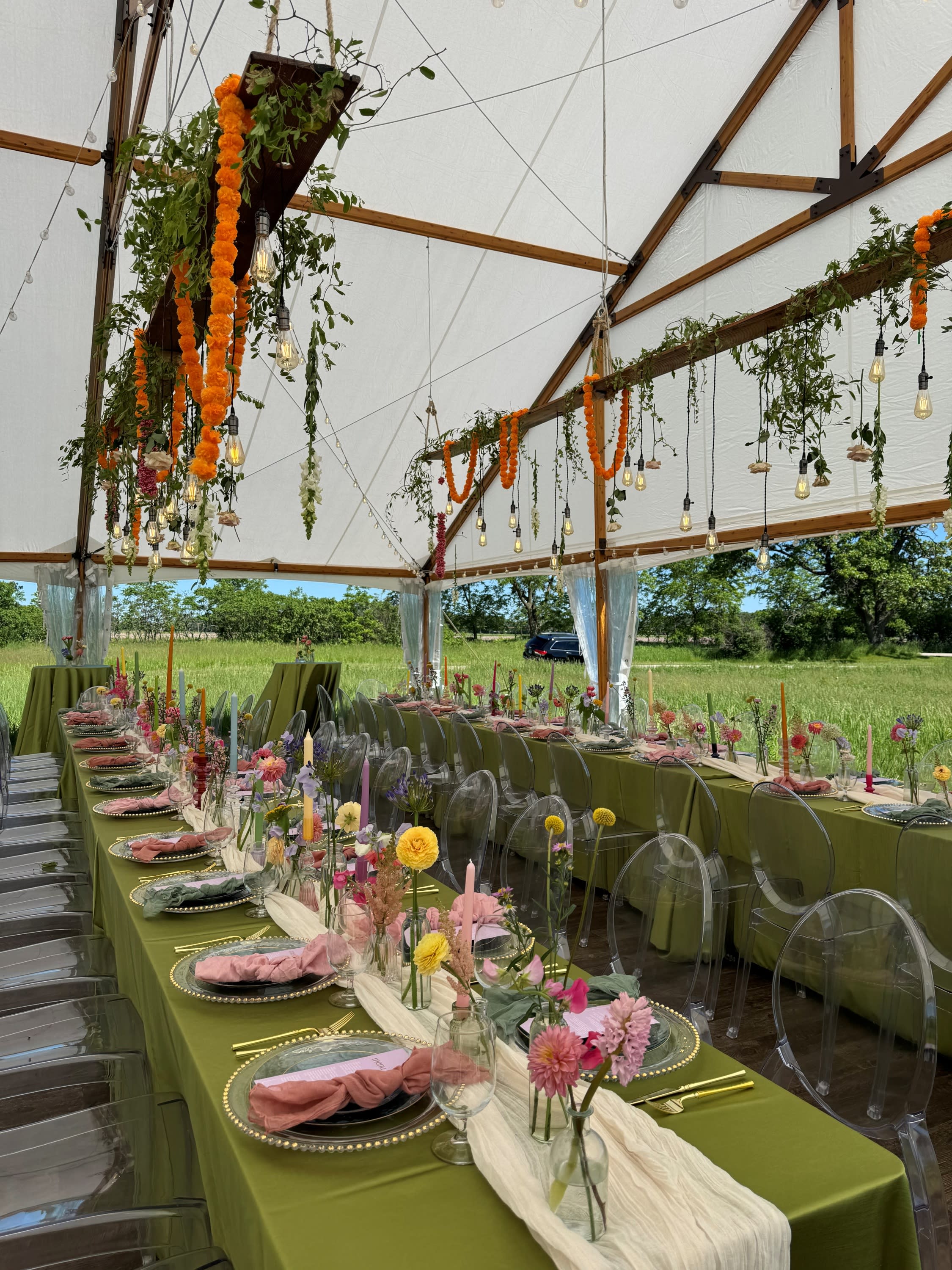 Fullyl set and decorated farm tables under a frame tent