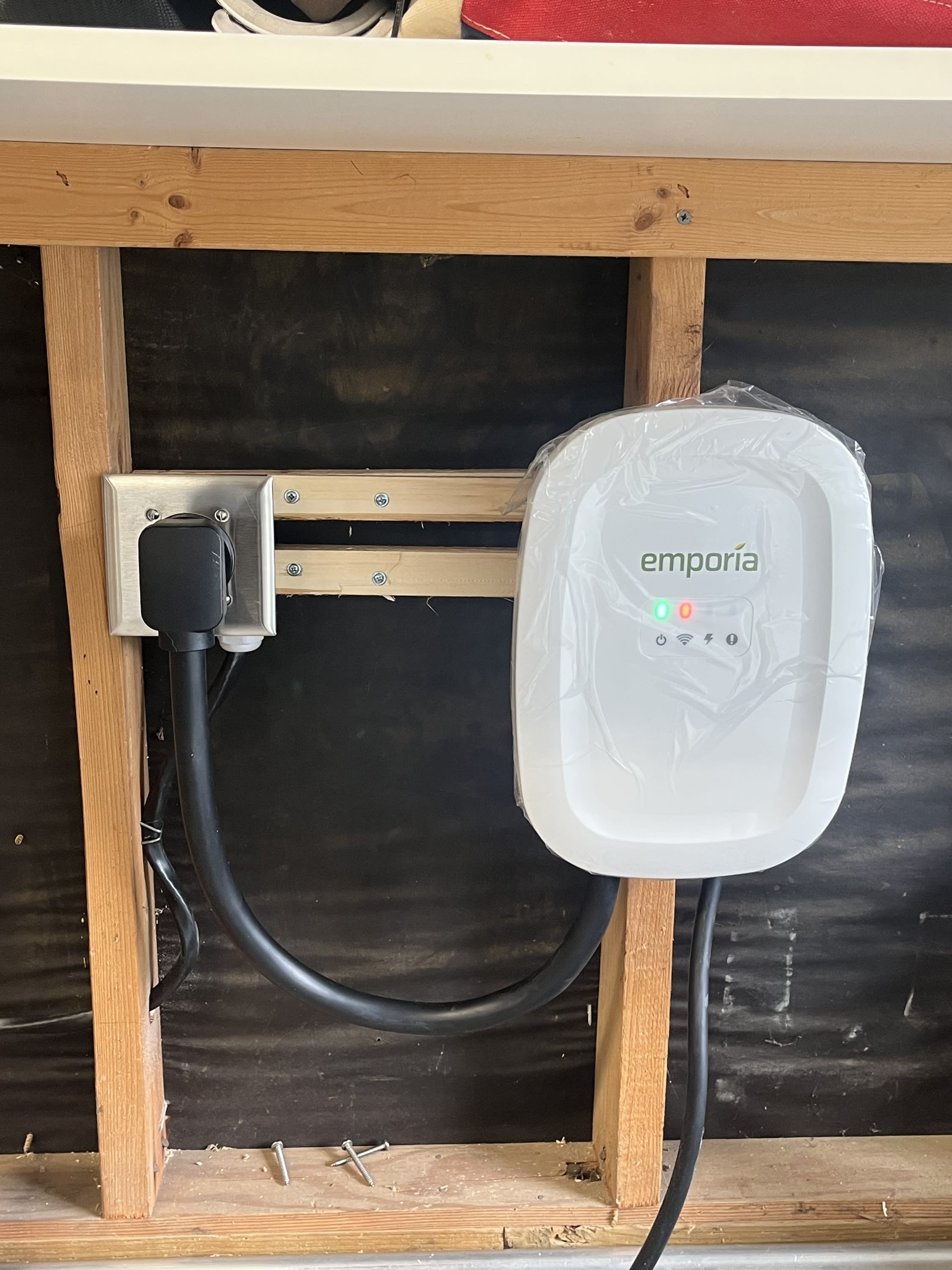 EV charger installation by Surge Electrical with clean wiring and wall-mounted unit in a residential garage.