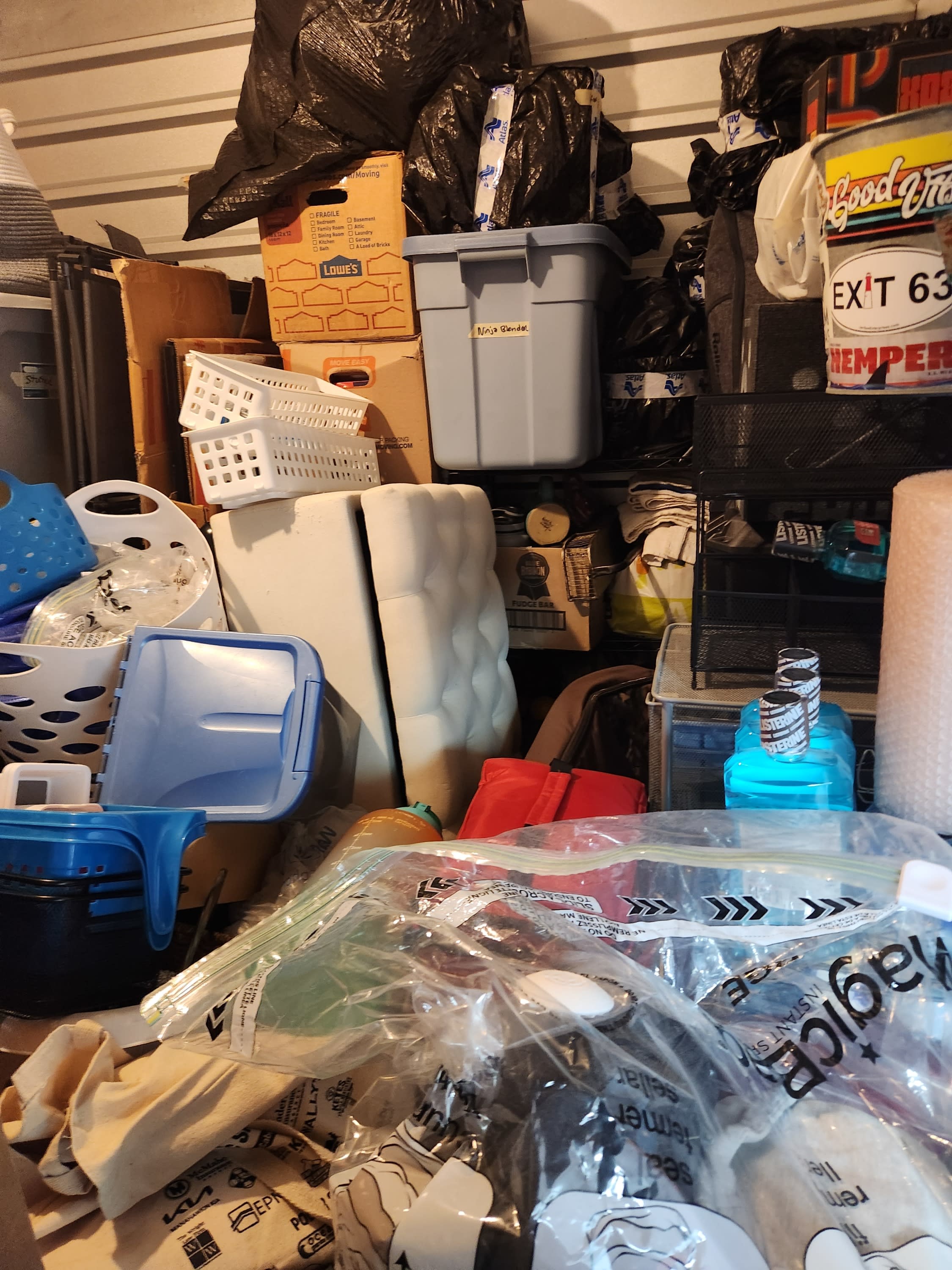 Packed garage storage unit before organization and declutter.