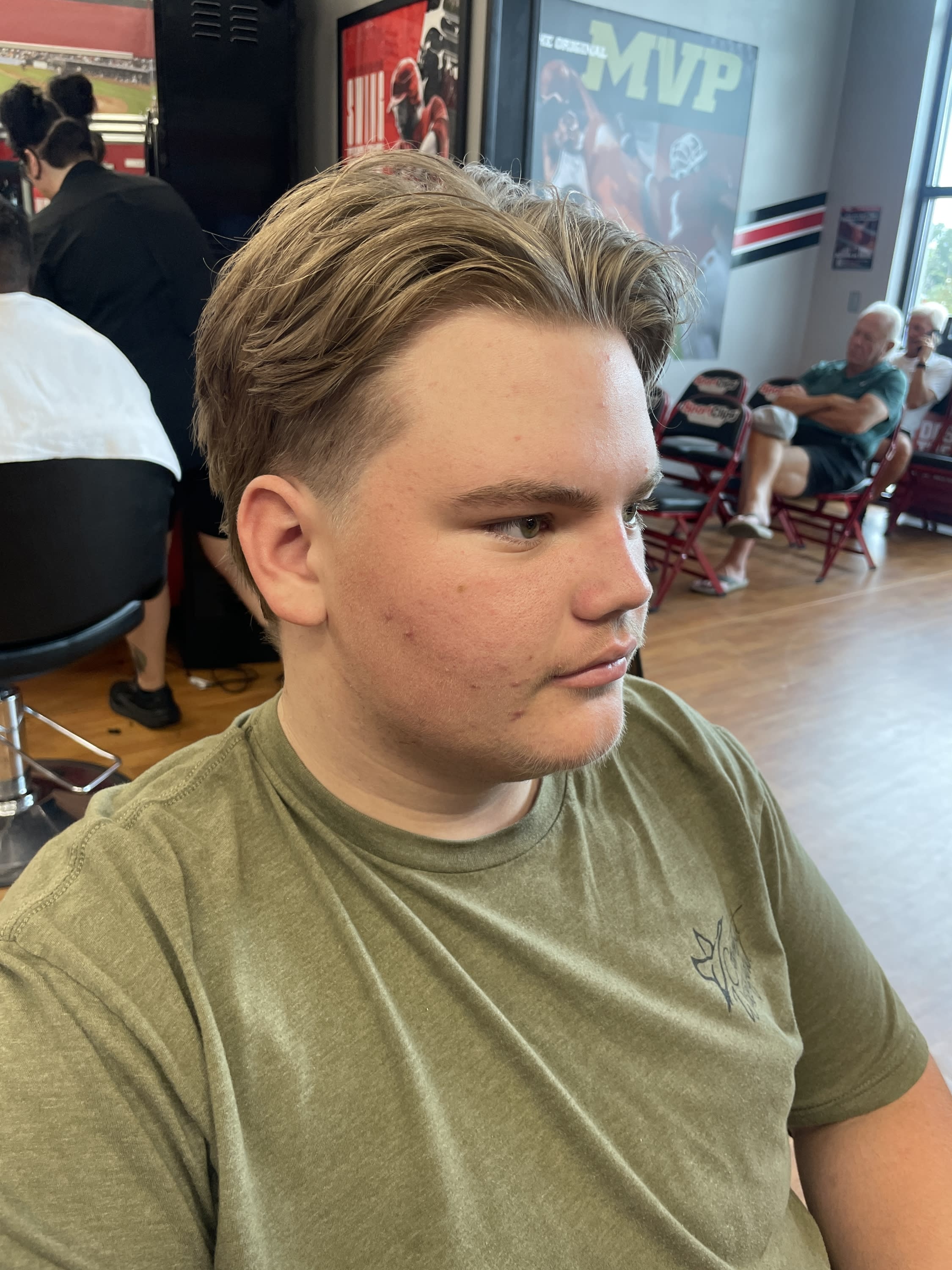 Gentlemen's scissor cut with modified undercut on a men's haircut transformation executed by Savannah at Sport Clips Haircuts
