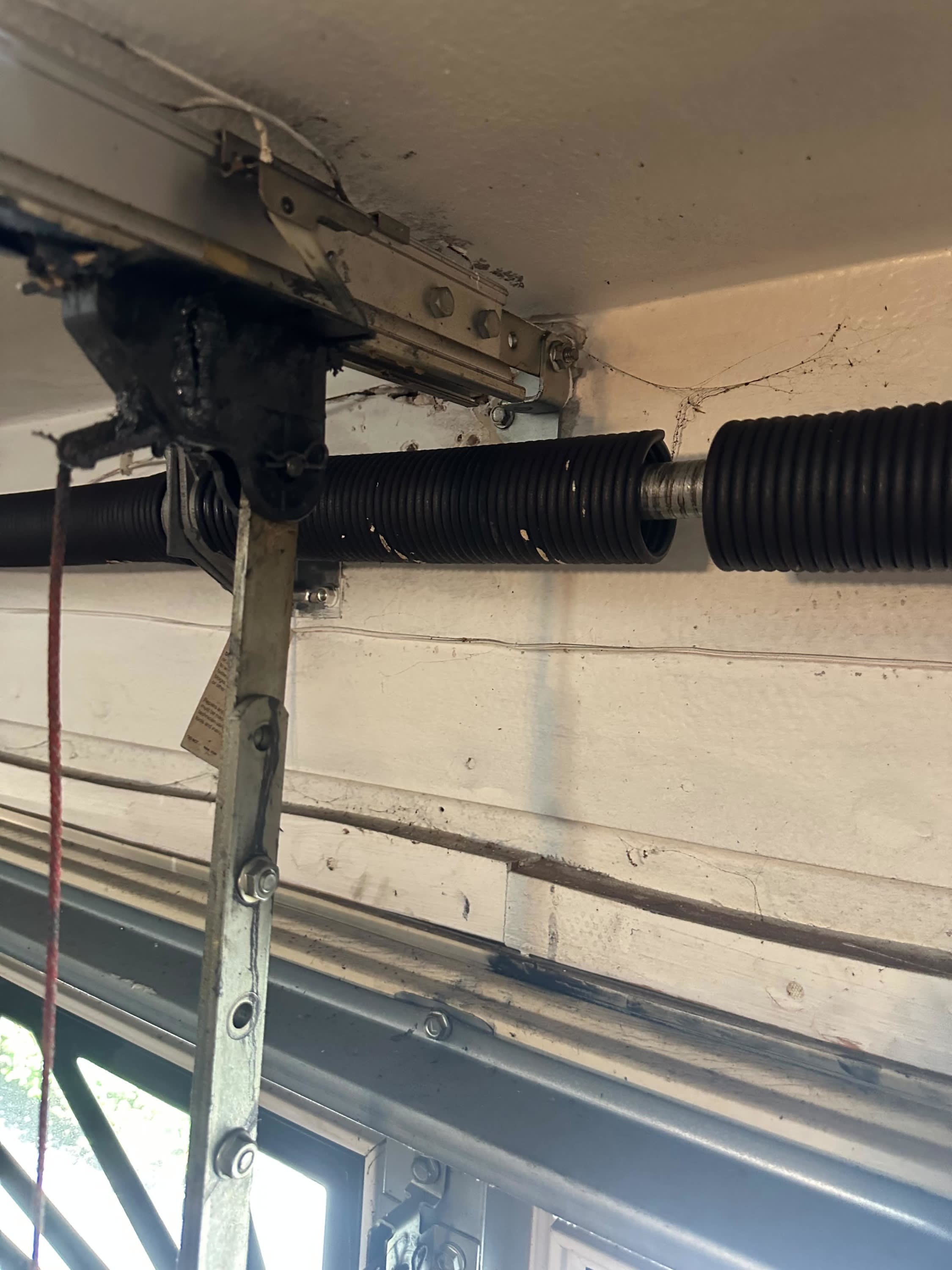 Broken garage door torsion spring above the garage door