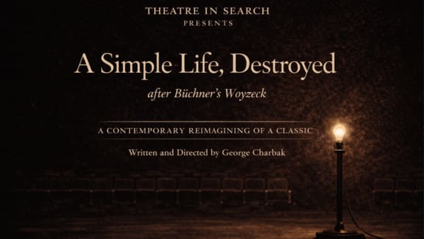 A dark, empty theatre stage is illuminated by a single glowing ghost light standing to the right, with rows of empty seats fa