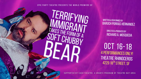 A dark-haired, light-skinned and bearded man is wearing a sparkly outfit with his hand pressed against the screen against a p