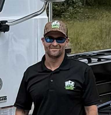 Justin wearing 864 dumpster uniform