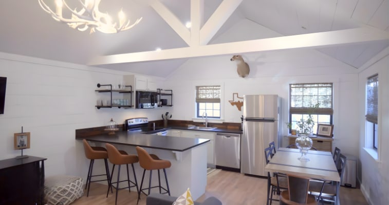 Modern kitchen inside a campground rental cabin with island seating and full appliances