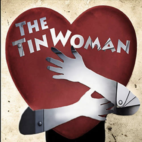 tin woman hugging a heart