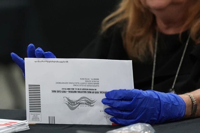 An election worker sorts vote-by-mail ballots at the Miami-Dade County Supervisor of Elections Office for the Florida primary