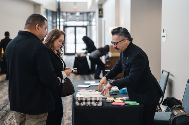 William Garay Jr. working with business owners at a workshop table