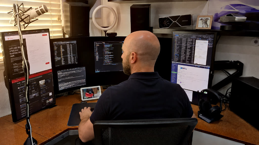 Mike Johnstone working sitting at his desk looking at his computer screens