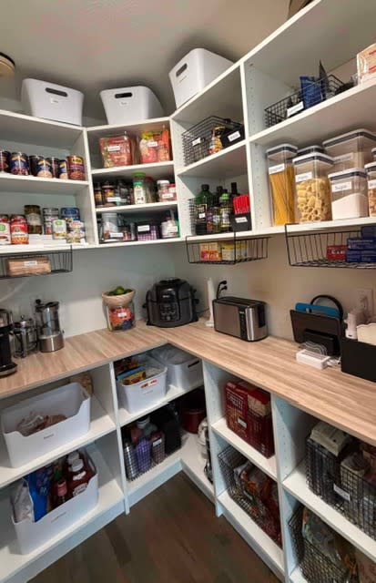Organized pantry with labeled storage, kitchen appliances, and clear countertop space
