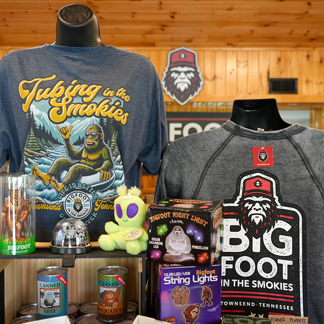 Custom apparel and unique gifts displayed in a retail store with wood paneling on the walls and ceiling