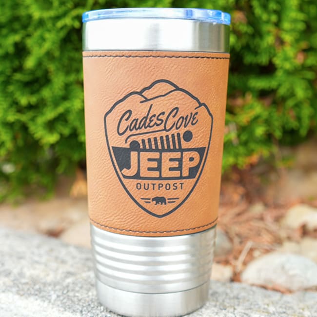 Silver insulated tumbler with a leather custom laser engraved koozie