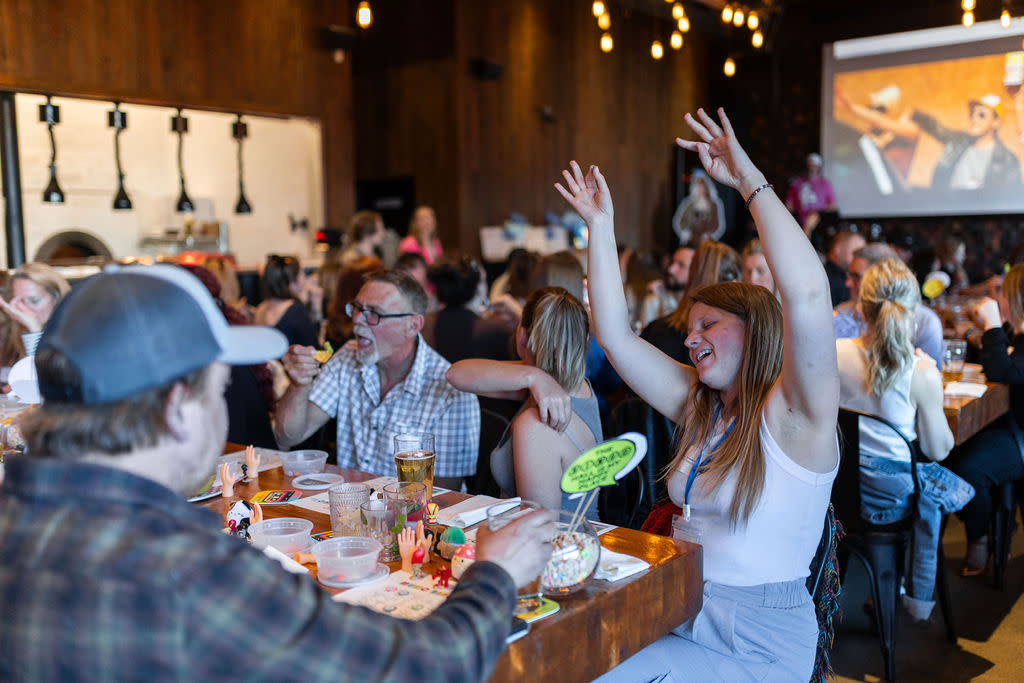 girl singing with her hands in the air.