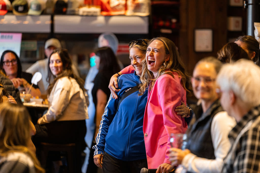 EO and board president hugging and laughing.