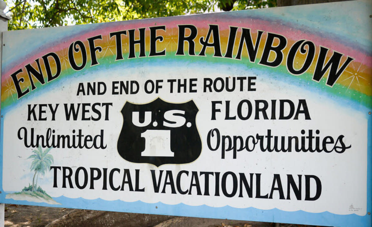 Colorful sign reading End of the Rainbow marking U.S. Route 1 in Key West Florida vacation destination