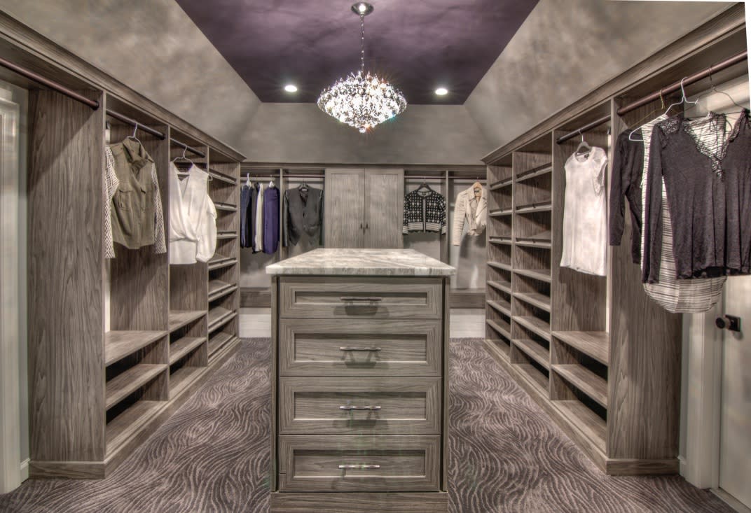 Custom Closet, island with drawers, angled ceiling and attic access