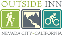 Outside Inn with hiking sign, river sign and biking sign in cool green color scheme